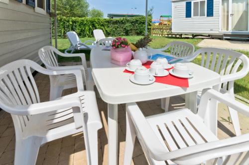 a white table and chairs on a patio at Campeggio del Garda in Peschiera del Garda