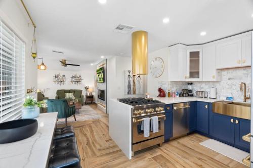 a kitchen with blue cabinets and a stove top oven at 3BD Spa & Heated Pool Old Town Vista Del Camino in Scottsdale