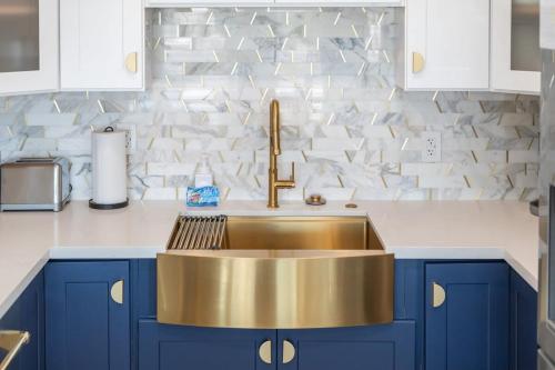 a kitchen with a gold sink and blue cabinets at 3BD Spa & Heated Pool Old Town Vista Del Camino in Scottsdale