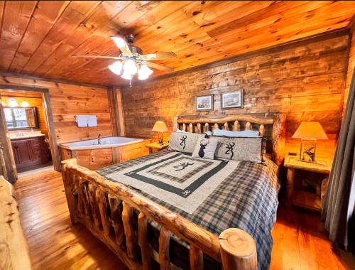 ein Schlafzimmer mit einem Bett in einem Blockhaus in der Unterkunft Stairway to Heaven - 3 Master Suite, Location, Privacy, Firepit in Gatlinburg