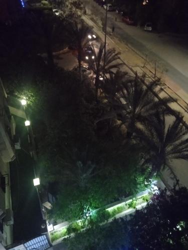 an overhead view of a street at night with palm trees at Studio in Cairo
