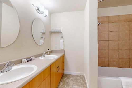 a bathroom with two sinks and a tub at The Last House On The Left in Redmond