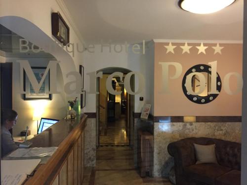 a lobby of a hotel with a sign on the wall at Boutique Hotel Marco Polo in Gradac