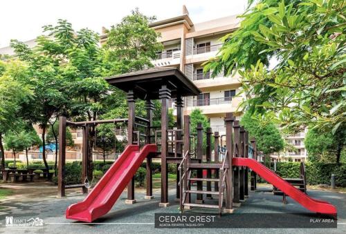 a playground in front of a building at City Haven: Modern Condo Retreat in Manila