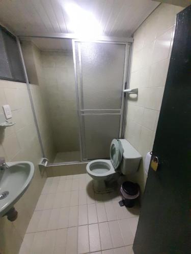 a bathroom with a shower and a toilet and a sink at HOTEL BS in Nemocón