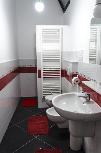 a bathroom with a white sink and two toilets at Maria Vittoria Charming Rooms and Apartments in Brindisi