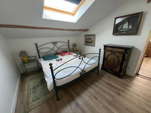 a bedroom with a bed and a skylight at LA CHEVRIÈRE EN PERIGORD in Villetoureix