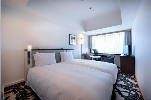 Postel nebo postele na pokoji v ubytování ANA Crowne Plaza Hotel Grand Court Nagoya by IHG