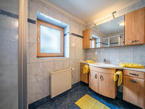 a bathroom with a sink and a mirror at Haus Christine in Niedernsill