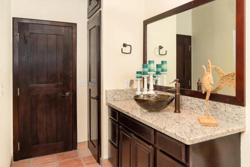 a bathroom with a sink and a large mirror at X'tan Ha- The Waterfront in San Pedro