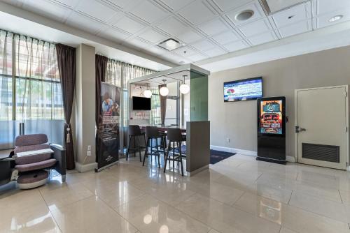 a lobby with a waiting room with a table and chairs at Crowne Plaza Hotel Orlando Downtown, an IHG Hotel in Orlando