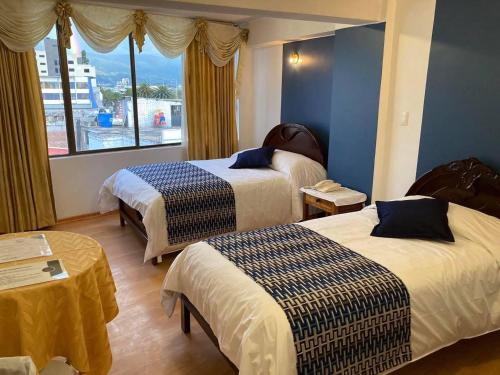 Ein Bett oder Betten in einem Zimmer der Unterkunft Hotel El Cisne Internacional