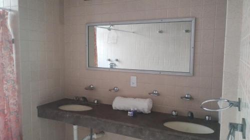 a bathroom with two sinks and a large mirror at PROVENZA HOTEL & SUiTES in Atlixco