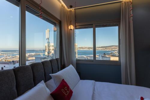 a bedroom with a bed and a view of the ocean at Marina View Residence, Luxury Studio, Ocean View, Enjoy Starlink High Speed WiFi, IPTV, PlayStation PS4 Plus, Near TGV, Airport Bus, Taxi, Indrive, and so on in Tangier