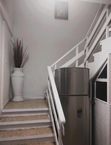 a refrigerator in a room with stairs with a plant at PROVENZA HOTEL & SUiTES in Atlixco