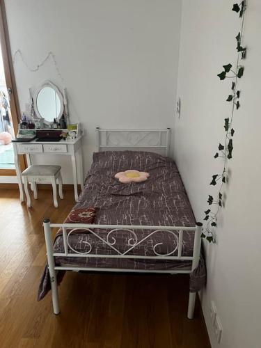 Ce lit se trouve dans un dortoir doté d'une table et d'un miroir. dans l'établissement Appartement cosy de 3 pièces, à Bagneux