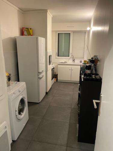 une cuisine avec un réfrigérateur et une machine à laver dans l'établissement Paris 17, à Paris