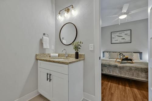 a bathroom with a sink and a mirror and a bed at Nashville - 805B Bradford Ave #102 in Nashville