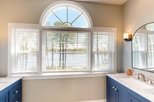 a bathroom with two sinks and two windows at Crane's Landing in Mineral