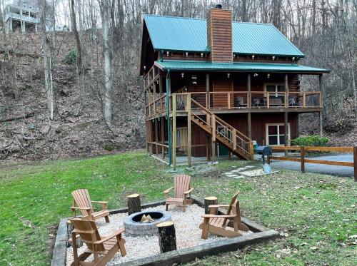 a log cabin with chairs and a fire pit at Stairway to Heaven - 3 Master Suite, Location, Privacy, Firepit in Gatlinburg