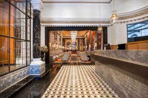 a view of the lobby of a hotel with a bar at Hotel Palacio del Retiro, Autograph Collection in Madrid