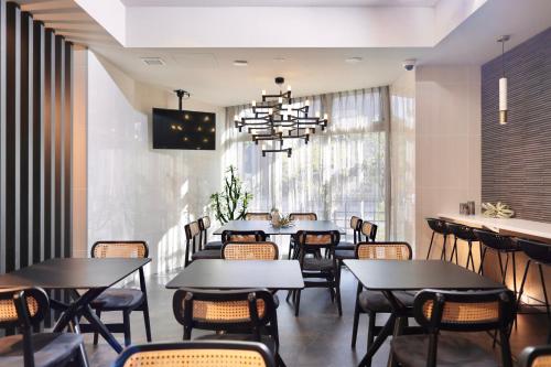 a dining room with tables and chairs and a chandelier at Tennouji Crystal Hotel in Osaka
