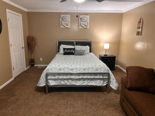 a bedroom with a bed and a couch at A huge Sprawling House on a large lot -15 minutes to St Louis in Belleville