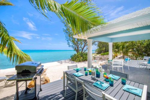 a table on the beach with a grill at Blue Moon home in Gun Bay