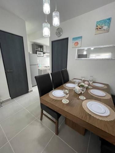 a dining room with a wooden table and chairs at Increíble Casa con alberca y club de playa in Barra Vieja