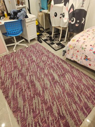 a bedroom with a bed and a rug at New Naseem block 3 in Jahra