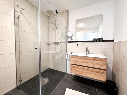 a bathroom with a sink and a shower at FEWO Kübler in Oberstaufen