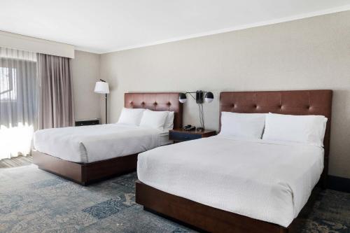 a hotel room with two beds and a window at Four Points by Sheraton Ventura Harbor Resort in Ventura