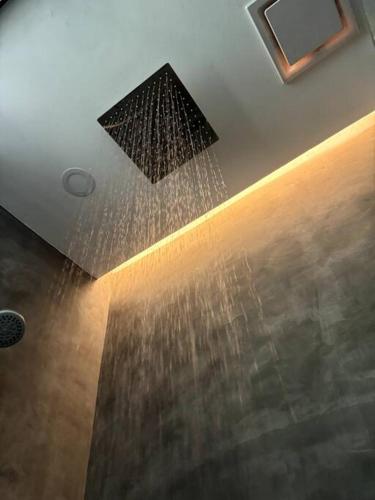 a ceiling with water pouring out of a ceiling at Villa Anela in Puerto Princesa City
