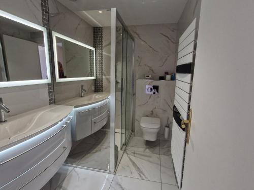 une salle de bain avec un lavabo, des toilettes et un miroir dans l'établissement Appartement 3 pièces climatisé avec piscine et accès plage - FR-1-780-53, à Sainte-Maxime