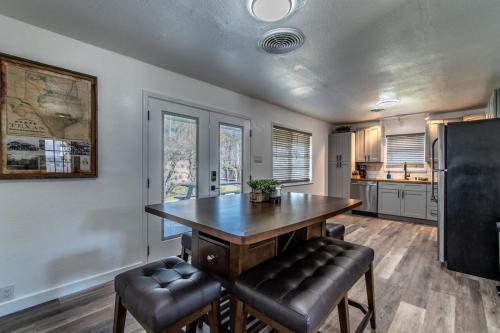 a kitchen with a large wooden table and leather stools at Gulfside Getaway Awaits in Corpus Christi