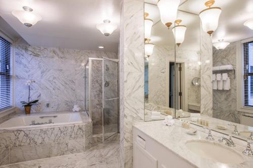 a bathroom with a tub and a shower and a sink at Hotel Cleveland Autograph Collection in Cleveland