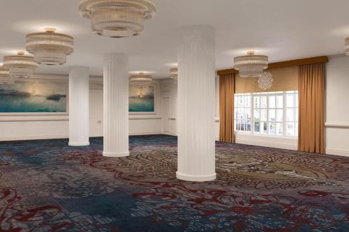 a large room with columns and paintings on the walls at Hotel Cleveland Autograph Collection in Cleveland