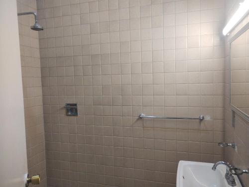 a bathroom with a shower with a toilet and a sink at PROVENZA HOTEL & SUiTES in Atlixco