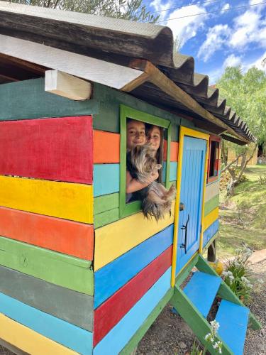 a colorful train house with a picture of a couple at VoyAca Hotel - Alfareria in Villa de Leyva