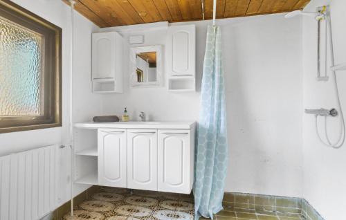 a bathroom with a sink and a shower curtain at Cozy Home In Sandved With Wifi in Sandved