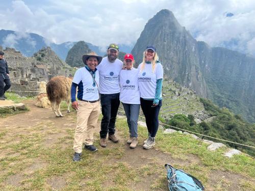 a group of people standing on top of a mountain at Hotel Chinchero Boutique & Tours in Chinchero