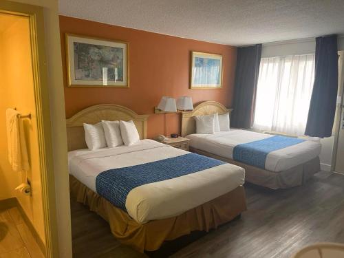 a hotel room with two beds and a window at Travelodge by Wyndham San Francisco Airport North in South San Francisco