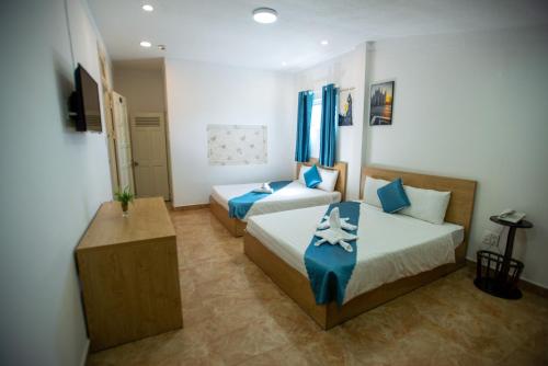 Postel nebo postele na pokoji v ubytování Thanh Thanh Spa & Hotel