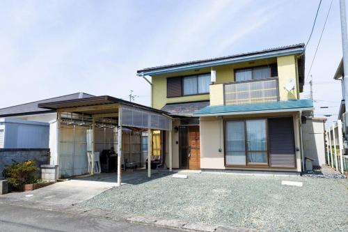 a house with a driveway in front of it at Shiga Lakeside House in Hamabun in Imazu