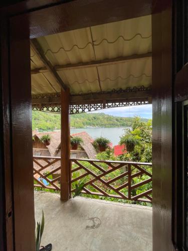 a view from the porch of a house with a view of the water at Camiguin Blue Lagoon Cottages in Mahinog