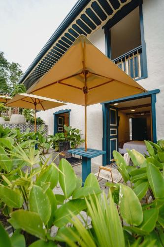 a patio with a blue table and an umbrella at Cocli Hotel Boutique Salento in Salento