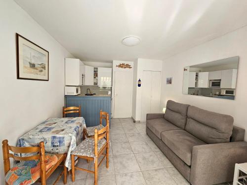 un salon avec un canapé et une table dans l'établissement Studio Cozy à 3 min de la Plage avec Parking et Balcon - FR-1-550-74, à Saint-Georges-de-Didonne