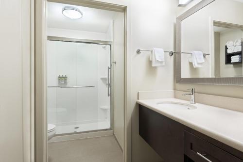 La salle de bains est pourvue d'un lavabo et d'une douche. dans l'établissement Staybridge Suites - Miami International Airport, an IHG Hotel, à Miami