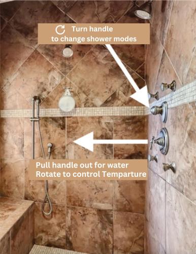 a shower in a bathroom with a stone wall at Ultimate Vacation: A Luxurious Oasis with a Pool! in Las Vegas