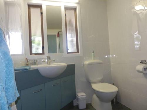 uma casa de banho com um WC, um lavatório e um espelho. em The Rise em Napier